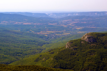 landscape of mountain slopes and trees