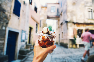 Tourist holds Fritule on street in Croatia. Croatian homemade fritters