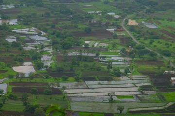 Fototapeta na wymiar Green landscape surrounded by hills, mountains in monsoon season 