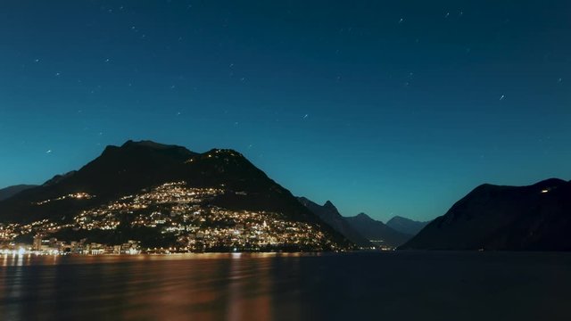 Time Lapse of Lake Lugano going from Night to Day, including Star Trails, Blue Hour, and Golden Hour.