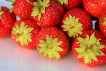 Strawberry ripe red delicious appetizing berry with tails on a white background