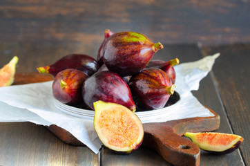 Group of fresh organic figs on rustic wood background. Seasonal autumn fruit. Concept for healthy...