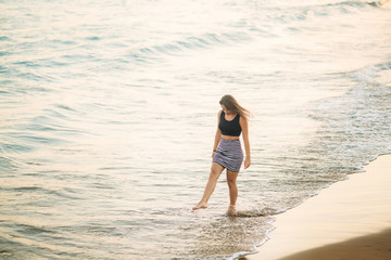 lady walks along the coast