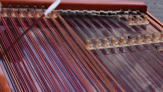 Man hands playing on a harp, the Ukrainian national musical instrument, close up. Lviv, Ukraine