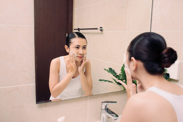 Obraz premium Asian woman cleaning face skin enjoy herself with bubble cleansing foam.