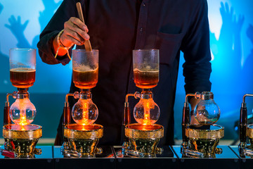 Siphon vacuum coffee maker and coffee grinder with drip brewing filtered coffee or pour-over is a method involves pouring hot water over roasted coffee beans contained in a filter old tradition