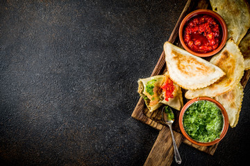Latin American, mexican, chilean food. Traditional baked pastry empanadas with beef meat, two spicy...