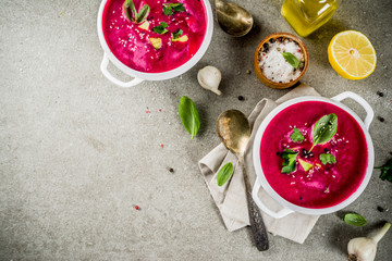 Vegan food, summer cold Beetroot gazpacho soup with lemon, avocado and fresh herbs copy space top...