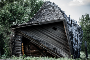 Ruin of old wooden house on the road from the Saint-Petersburg ещ Ьщысщц, Russia. A lot of masterpiece of wooden architecture are disappearing in modern circumstances.