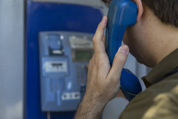  the man call someone with the blue pay phone 