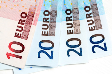 Euro notes of different value on a light background