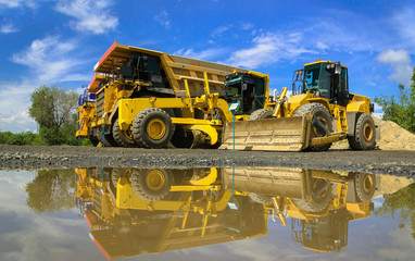 Group of working heavy equipment at open pit