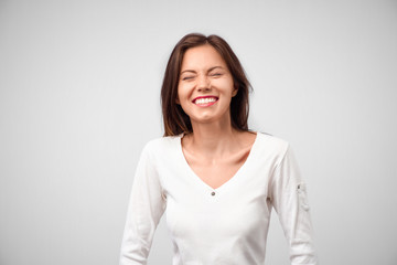Obraz premium Good-looking female with sincere smile rejoicing her success at work having good mood showing her positive emotions. Woman with gentle smile. People, happiness, facial expressions and emotions