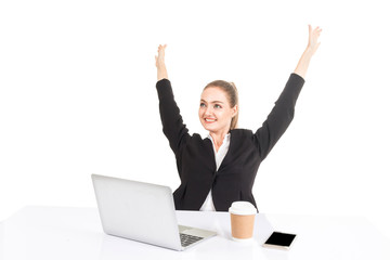 Successful businesswoman celebrating with arms up working project planning on the laptop computer isolated on white background