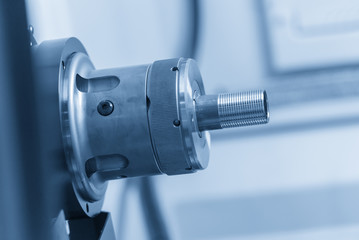 The CNC lathe machine or turning machine  cutting the thread at the end of  metal pipe or tube....