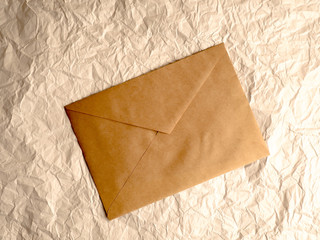 envelope of Kraft paper lies on crumpled paper.
