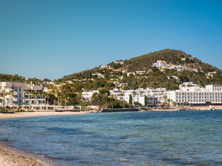 Seascape. Ship on the background of a coastline and a clear blue sky	