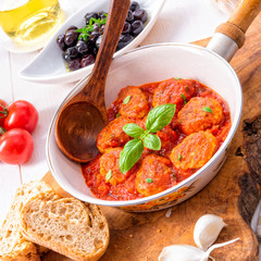 Baked mini meatballs in tomato sauce with basil