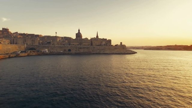 Cinematic aerial shot lifting, flying towards Valletta