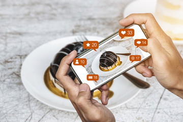 Taking dessert photograph by mobile smart phone, and sharing on social media, social network with notification icons