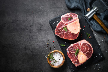 Raw beef steak osso bucco on black. Marble meat.