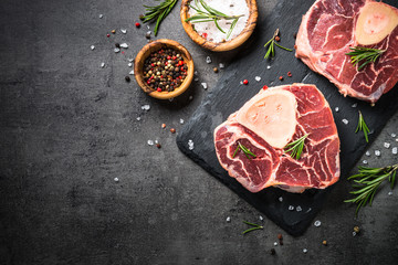 Obraz na płótnie Canvas Raw beef steak osso bucco on black. Marble meat.