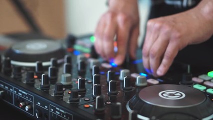 A video of a DJ using a music controller at a festival. This video was taken with a professional DSLR.