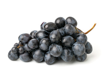 Bunch of blue grapes on a white.