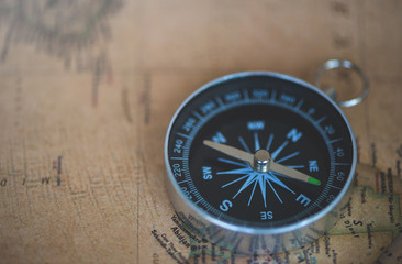 Fototapeta na wymiar Compass on the old map for adventure concept