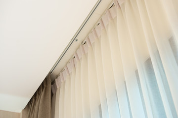 Curtain rail with white and brown curtain
