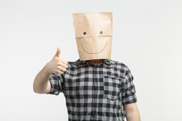 men in happy paper bag mask with thumbs up on white background