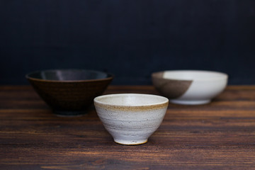 Empty Japanese  ceramic bowl on wooden table.