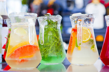 fruit drinks in decanters and glasses