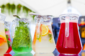 fruit drinks in decanters and glasses