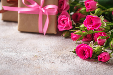 Pink roses and gift boxes with ribbons