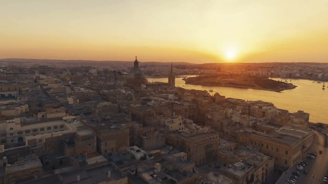 Aerial shot moving backwards at Sunset in Valletta, Malta