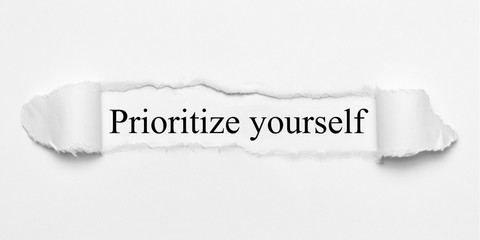 Prioritize yourself on white torn paper