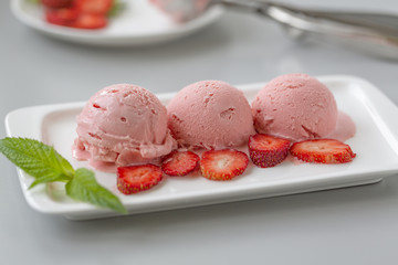 Tasty creamy strawberry ice cream with fresh ripe red succulent fruit 