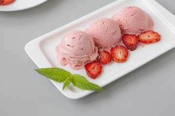 Tasty creamy strawberry ice cream with fresh ripe red succulent fruit 