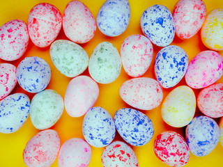 colored eggs for Easter on a bright yellow background, copy space for text, sun.