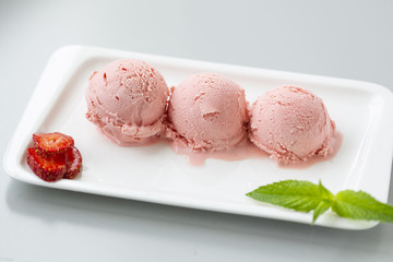 Tasty creamy strawberry ice cream with fresh ripe red succulent fruit 