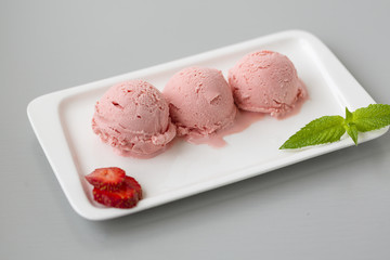 Tasty creamy strawberry ice cream with fresh ripe red succulent fruit 
