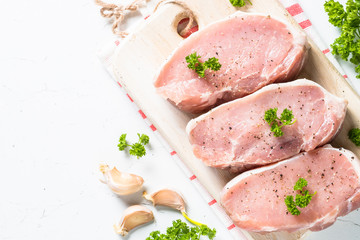 Pork meat steak on white top view. 