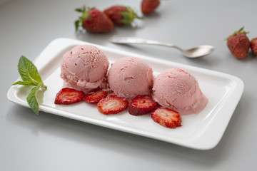 Tasty creamy strawberry ice cream with fresh ripe red succulent fruit 