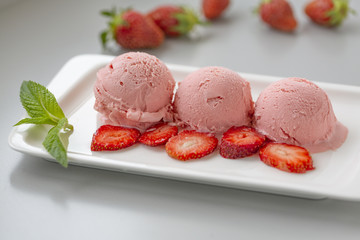 Tasty creamy strawberry ice cream with fresh ripe red succulent fruit 