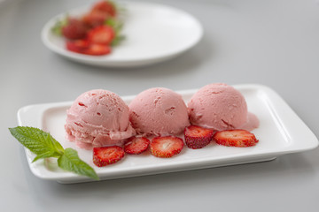 Tasty creamy strawberry ice cream with fresh ripe red succulent fruit 