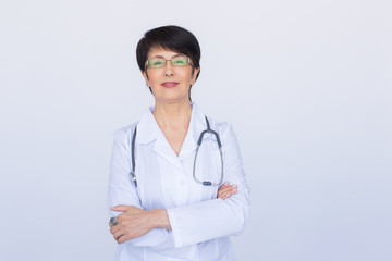 Fototapeta premium Smiling medical doctor woman with stethoscope. Over white background