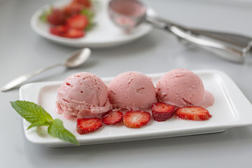 Tasty creamy strawberry ice cream with fresh ripe red succulent fruit 