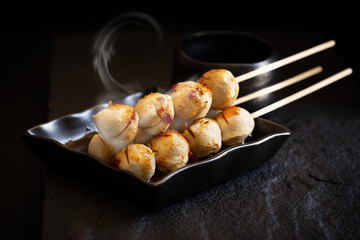 Roasted pork ball pour with sweet spicy sauce on dark background