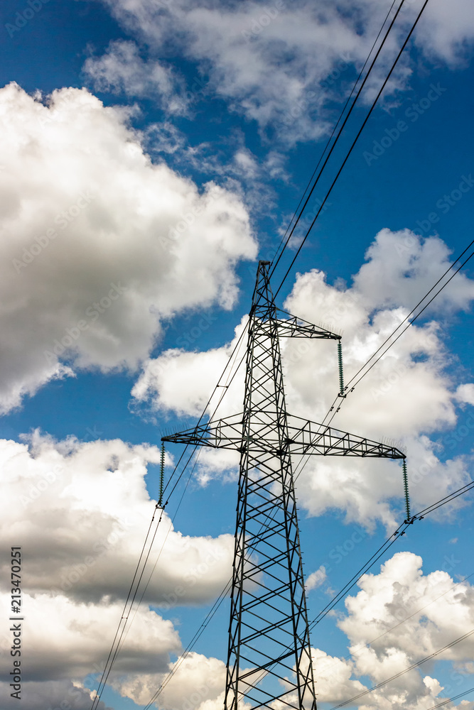 Wall mural power pylons and high-voltage lines against the background of the cloudy sky, power lines.